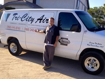 Chris, Tri-City Air's owner, standing beside his service van